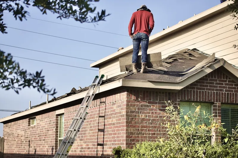 Professional roofer working on a residential roof in Thurston